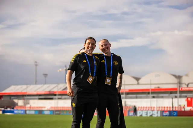 Rachel Williams and Leah Galton of Manchester United inspect the pitch