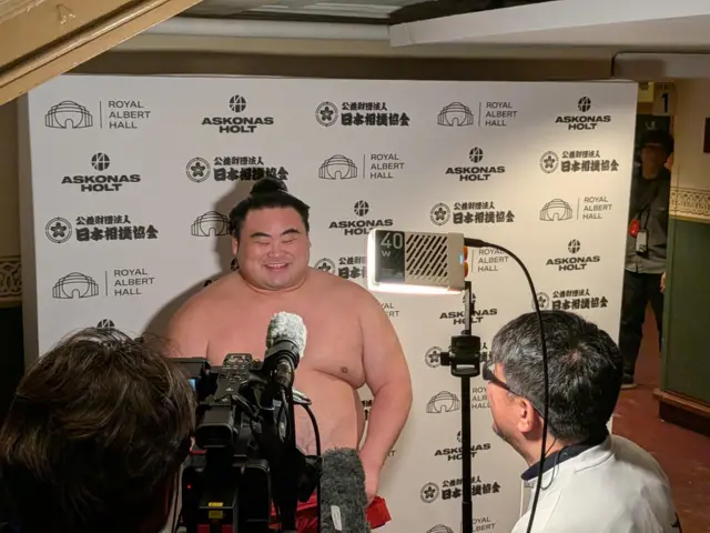 Takanosho looks very pleased about his win, talking to Japanese media in the backstage