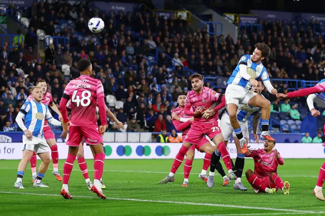 Leo Castledine of Huddersfield Town scores the opening goal