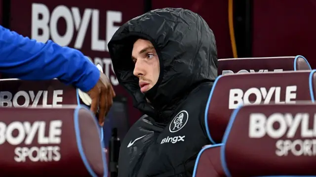 Cole Palmer of Chelsea is seen sat on the bench