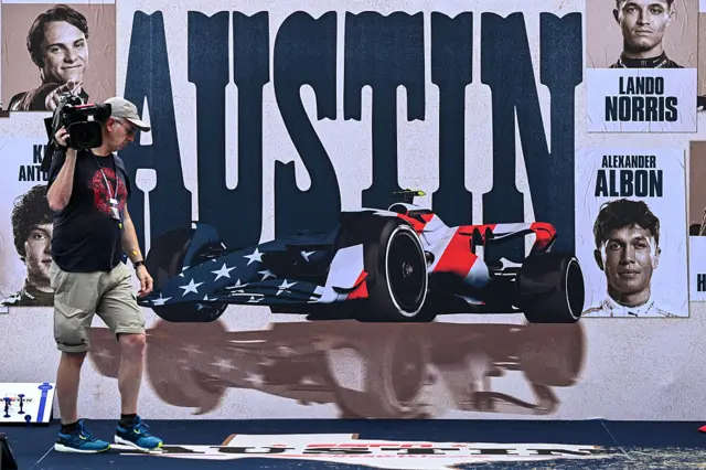 A cameraman walks in the paddock ahead of the United States Grand Prix at the Circuit of the Americas in Austin