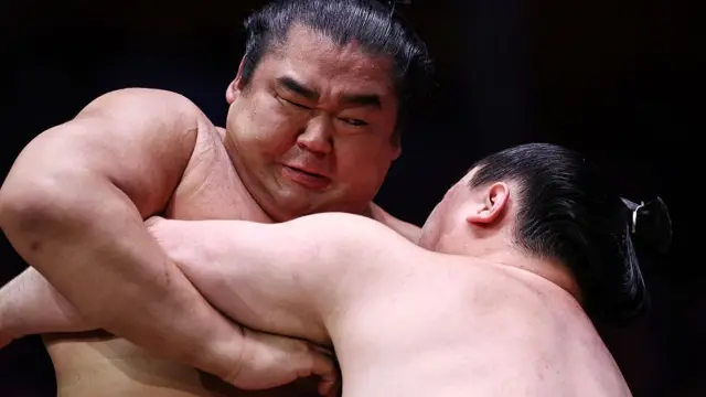 Shonannoumi (L) battles with Tokihayate (R) during their bout during the Grand Sumo Tournament at the Royal Albert Hall in central London