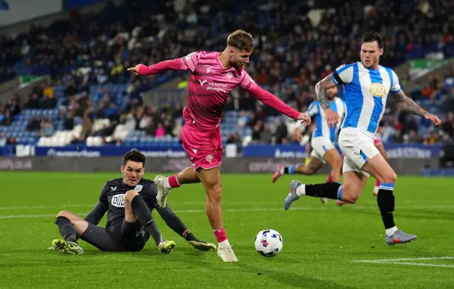 Bolton Wanderers' John McAtee rounds Huddersfield Town goalkeeper Lee Nicholls