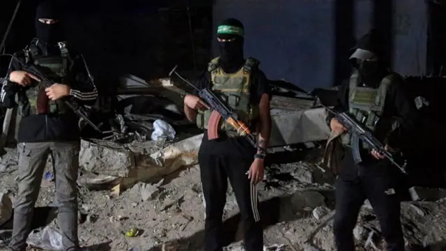 Hamas fighters at the handover of two Israeli hostages' bodies in Gaza last night