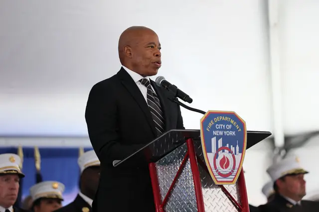 Eric Adams, mayor of New York City, stands behind a lectern with a Fire Department of New York sign on it