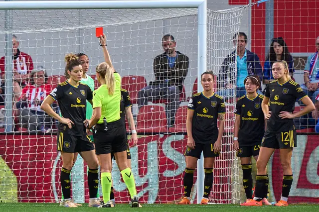 Dominique Janssen of Manchester United women is shown a red card