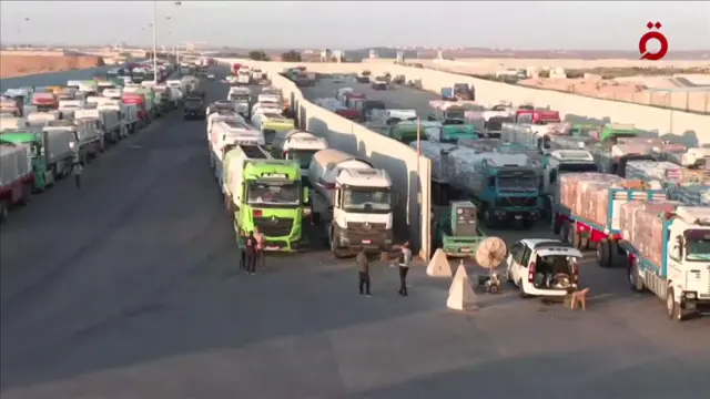 Trucks can be seen queueing in the morning light at a border crossing