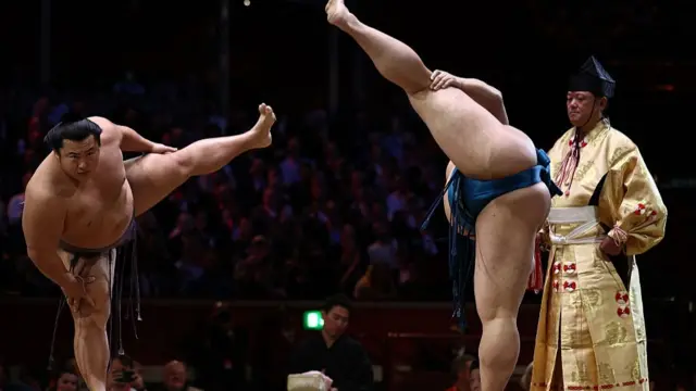 Tobizaru (L) and Kotoeiho (R) stamp the ground before their bout during the Grand Sumo Tournament at the Royal Albert Hall in central London o