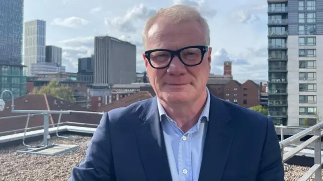 Richard Parker in thick glasses on a rooftop