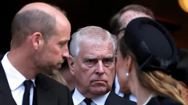 Prince Andrew stands next to Prince William and his wife Catherine
