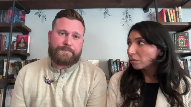 Sky and Amanda Roberts look at the screen during interview