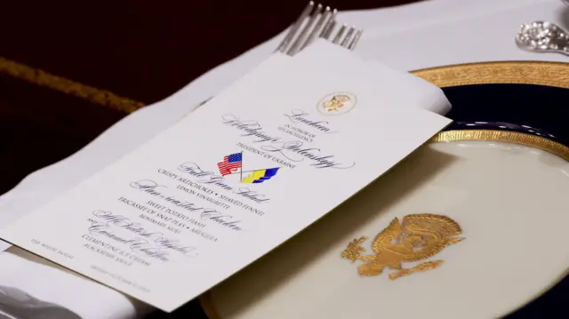 A menu sits on top of a gilded plate ahead of a White House lunch in honour of Ukrainian President Volodymyr Zelensky