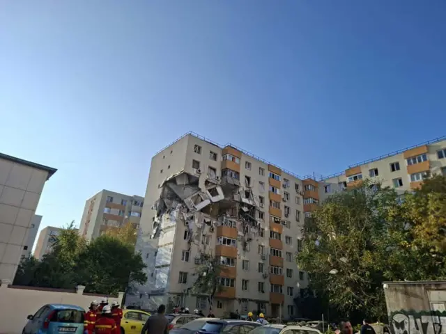 Damage can be seen on at least two upper floors of the apartment block in Bucharest