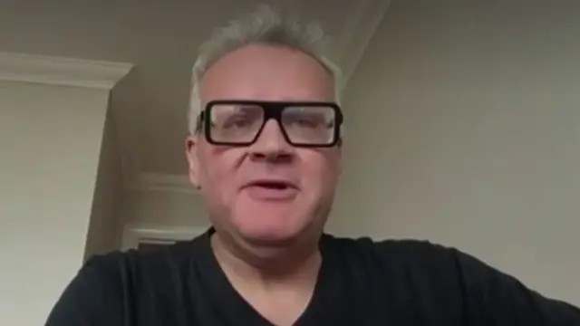 Johnny Gould speaking into a webcam