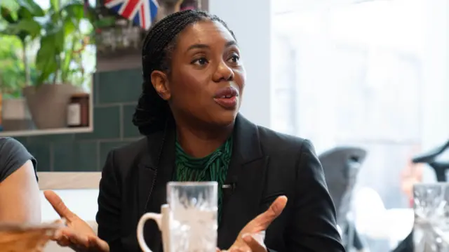 A headshot of Kemi Badenoch mid-speaking