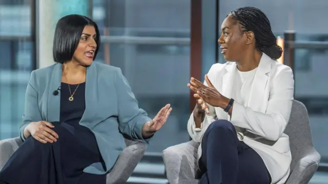 Kemi Badenoch, pictured on the right, smiles as Shabana Mahmood, on the left, gestures in her direction.