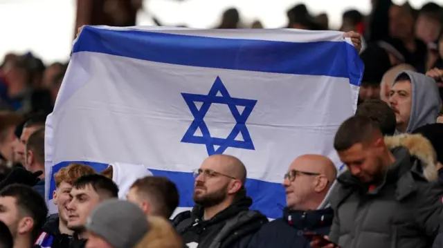 Football supporters wave an Israeli flag at a football match in Aberdeen in 2023.
