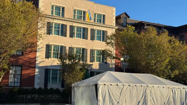 Exterior of Blair House with a large white tent and a Ukrainian flag