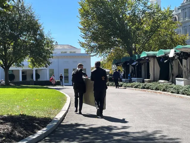 Men carrying a large box