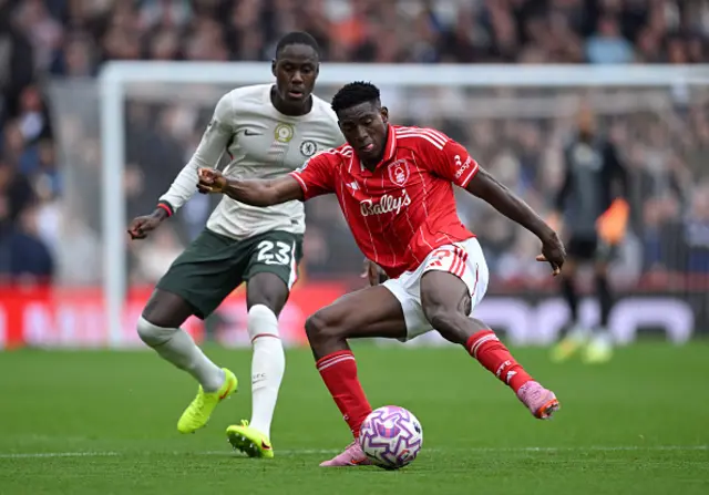 Taiwo Awoniyi of Nottingham Forest controls the ball whilst under pressure from Trevoh Chalobah