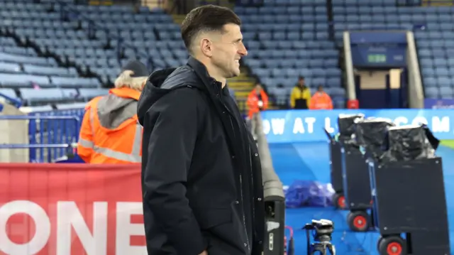 Portsmouth boss John Mousinho looks on from the sidelines at the King Power Stadium