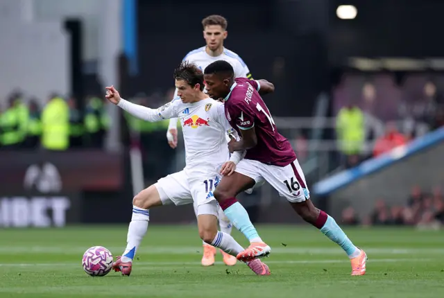 Brenden Aaronson of Leeds United is challenged by Floretino Luis of Burnle