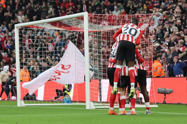 Players celebrate the second Sunderland goal, an own goal