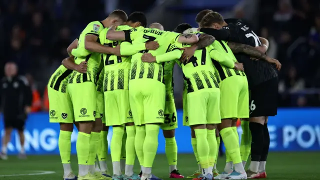 Portsmouth players huddle before kick-off