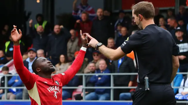Daniel Udoh of Salford City celebrates scoring a goal against Oldham