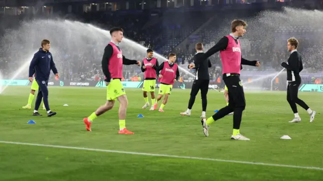 Portsmouth subs warm up during the half-time interval