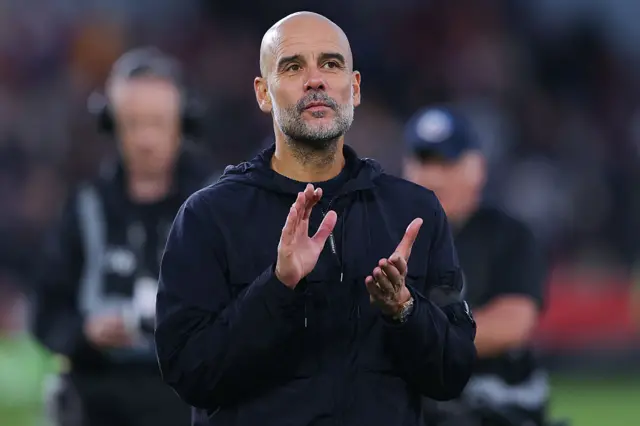Pep Guardiola applauds after beating Brentford