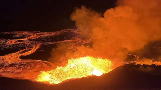 Halemaumau Crater in Kaluapele (Kilauea summit caldera) erupting as Hawaiian Volcano Observatory geologists visit the western rim of Halemaumau crater to observe Kilauea summit eruption