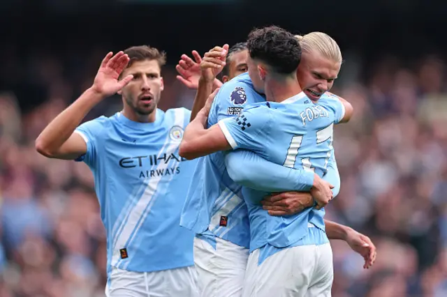 Erling Haaland of Manchester City celebrates with Phil Foden