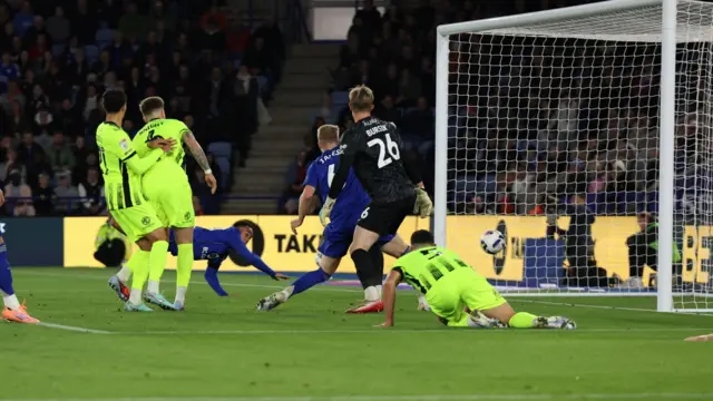 Leicester's Aaron Ramsey watches as the ball crosses the line