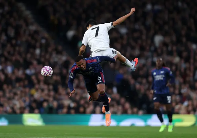 Gabriel of Arsenal collides with Raul Jimenez of Fulham as they compete