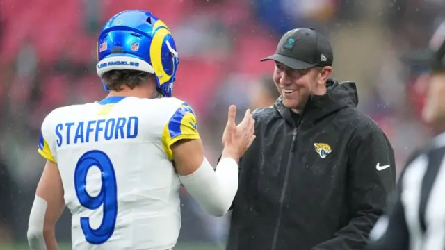 Los Angeles Rams quarterback Matt Stafford shakes hands with Jaguars head coach Liam Coen at Wembley