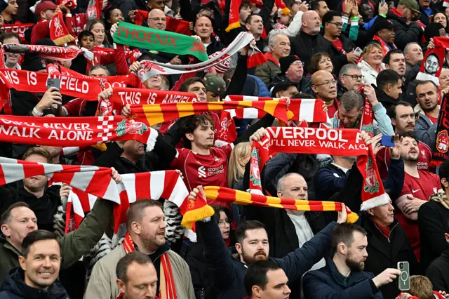 Liverpool fans lift scarves