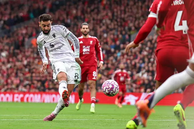 Fernandes curls wide from the edge of the box