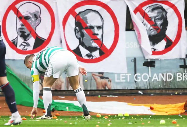 Celtic captain Callum McGregor joins in the clear up