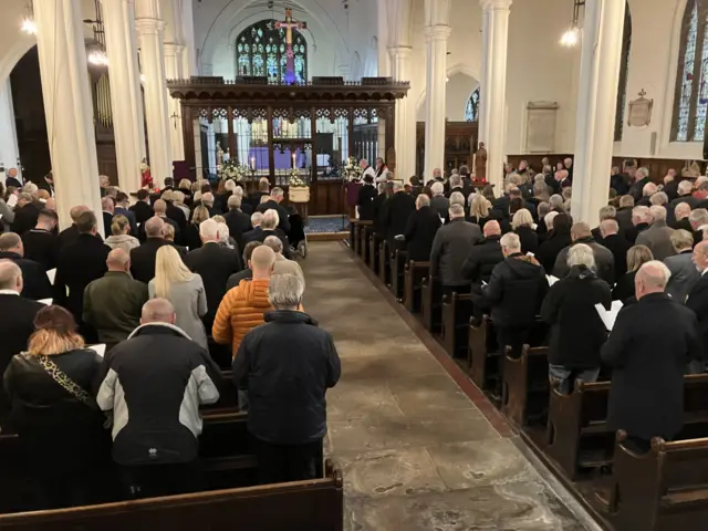 Mourners inside a church