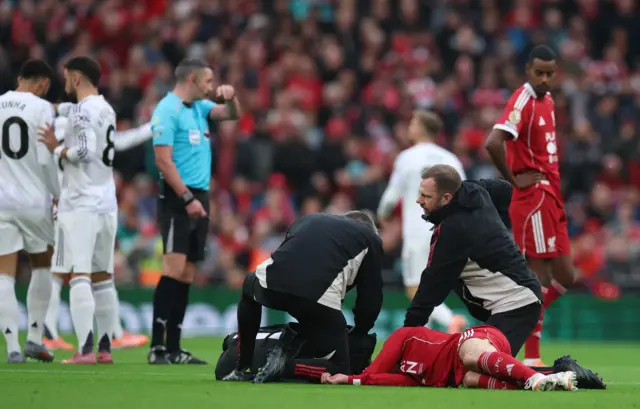 Mac Allister lies on the floor injured