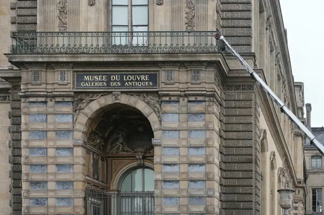 This photograph shows a furniture elevator propped up against a side of Louvre