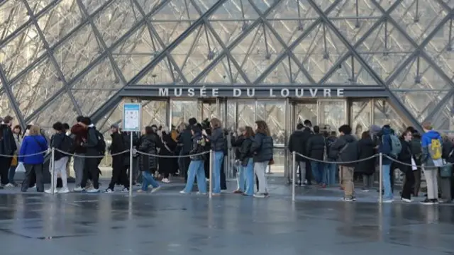 People visit the Louvre Museum