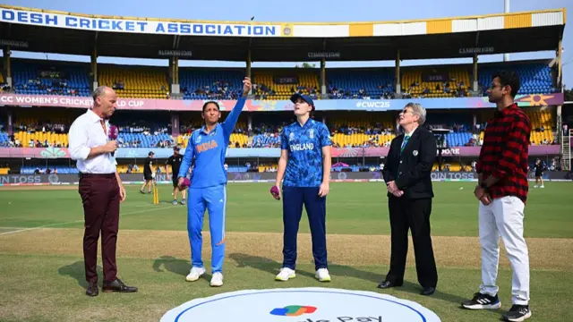 Harmanpreet Kaur of India tosses the coin alongside Nat Sciver-Brunt of England