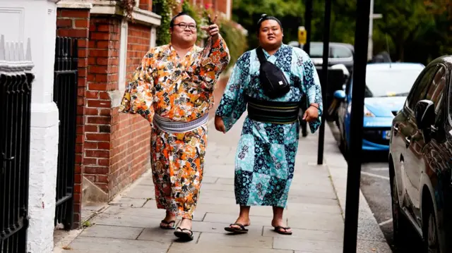 Sumo wrestlers on a walk in Kensington