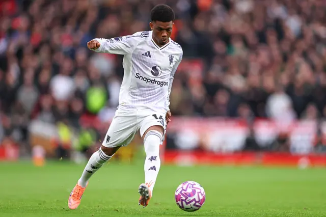 Amad runs down the wing with the ball