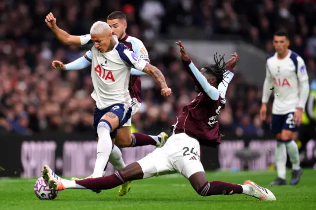 Tottenham Hotspur's Richarlison and Aston Villa's Amadou Onana battle for the ball