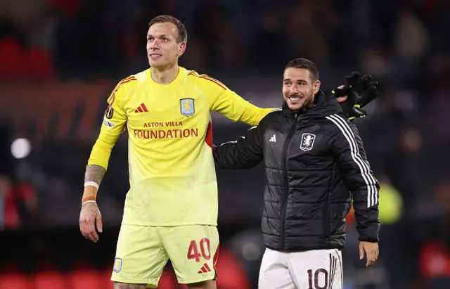 Marco Bizot and Emiliano Buendia of Aston Villa embrace