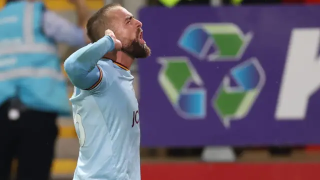 Bradford's Alex Pattison cups his ear in celebration