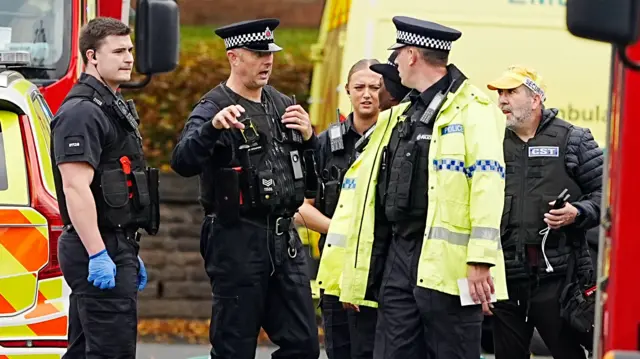 Emergency services talking at the scene